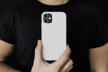 Man in black shows the phone in case mockup