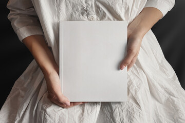 Woman in white presenting a book mockup