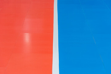 Blue and orange floor volleyball, basketball, badminton, futsal, handball court. Wooden floor of sports hall with marking lines line on wooden floor indoor, gym court