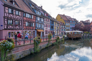 Fototapeta na wymiar Colmar, France - 09 16 2021: Typical houses and colorful facades in the little Venice.