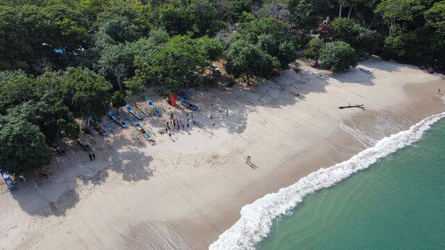 Aerial view of fishing boats and people at Tanjung Papuma Beach