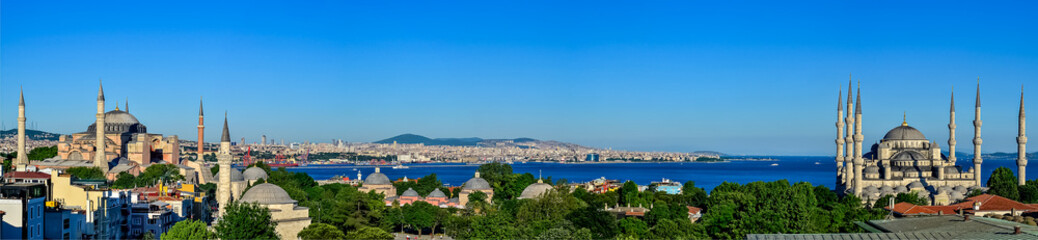 Fototapeta na wymiar The Blue Mosque, The Hagia Sophia and the Istanbul roofs, beautiful Marmara sea panorama 