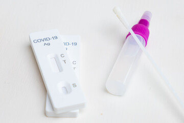 Rapid Antigen Test Covid-19 or SARS-Cov-2 kit with reagent and nasal swab stick on white background
