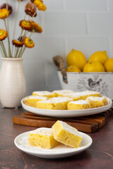 Homemade lemon bars dessert on a white plate on the table