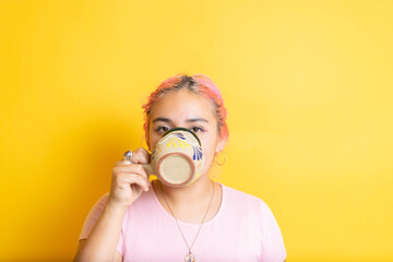 young mexican woman drinking mexican coffee in colorful cup