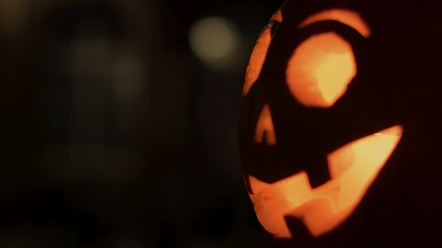 Close-up of smiling pumpkin decorated with face for the upcoming Halloween holiday - candle light inside