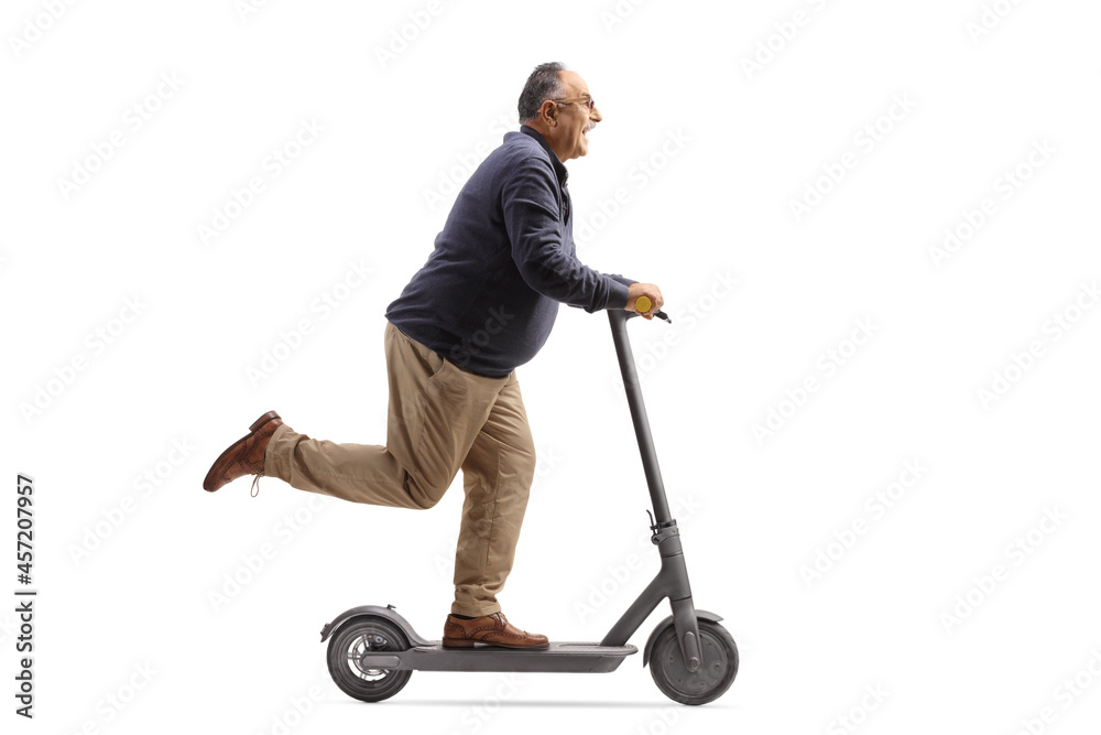 Wall mural cheerful mature man riding an electric scooter