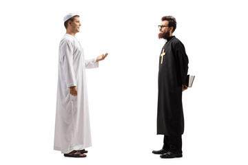 Full length profile shot of a man in ethnic clothes talking to a priest