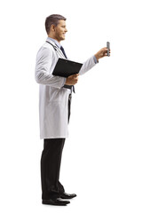 Full length profile shot of male doctor holding a smartphone