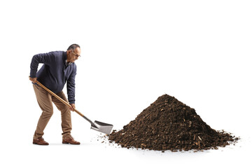 Mature man in casual clothes digging earth with a shovel