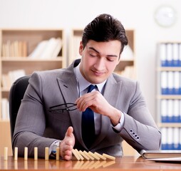 Businessman with dominoes in the office