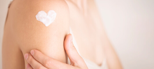 Woman gently cares for her body.