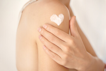 Woman gently cares for her body.