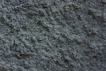 background of a gray, cement wall interspersed with frozen cement 