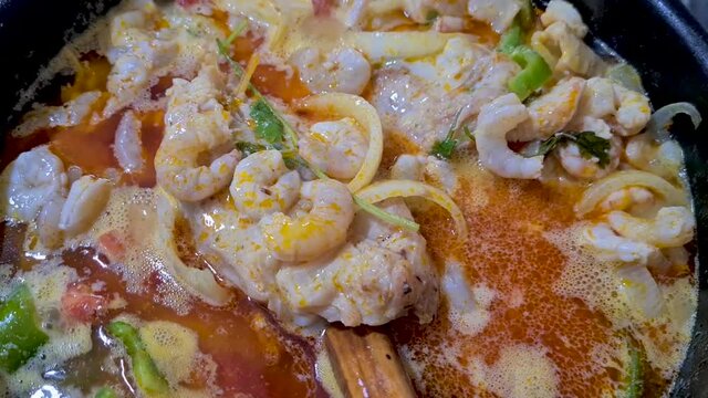Moqueca with shrimp, fish, palm oil, cilantro, coconut milk