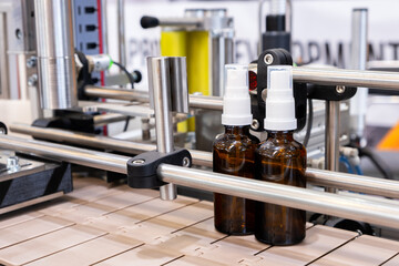 Bottles on the production line conveyor of the pharmaceutical industry. Machine for liquid drugs...