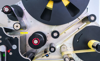 Fragment of the conveyor of sticking labeling machine. Abstract industrial background.