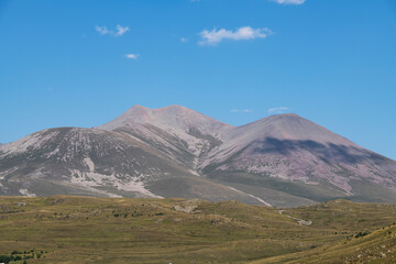 Fototapeta premium Beautiful mountains landscape, yellow hills blue sky.