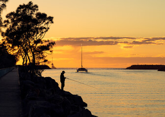Fishing and catamaran on the river at sunrise 