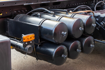 Air brake system of the truck. Black receivers with compressed air. Parts of a truck close-up - a...