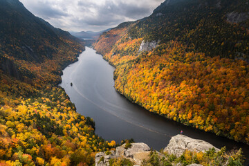 A hiker overlooking Lower Ausable Lake in New York's Adirondack Mountains.