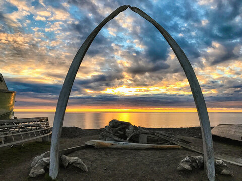 Beautiful sunset over the Arctic Ocean framed by the whale bones of a Bowhead.