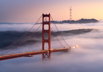 A classic scene, with very low fog flowing undernearh the Golden Gate Bridge, California