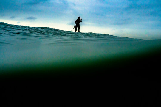 A woman paddle boards at Mondos, a surf spot in Ventura County California.