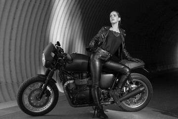 Obraz na płótnie Canvas young woman on a black motorcycle