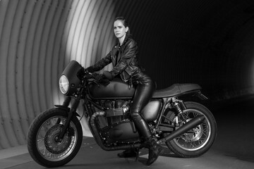 young woman on a black motorcycle