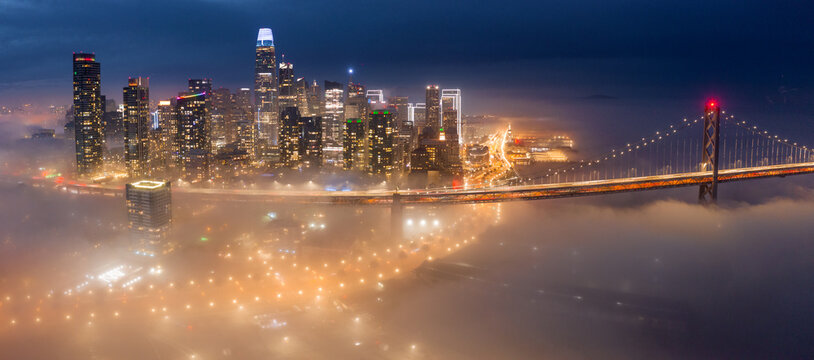 A rare evening patch of valley fog drifts into downtown San Francisco, California