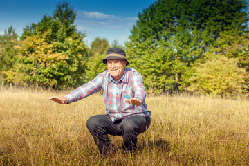 Naklejka na ściany i meble The older man is looking forward to beautiful nature and a healthy life