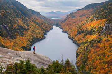 A hiker overlooking Lower Ausable Lake in New York's Adirondack Mountains.