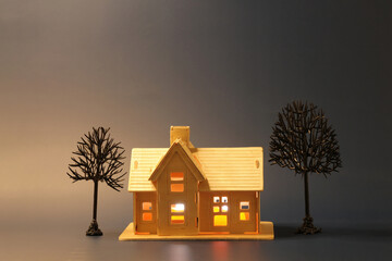 Halloween theme of single house with autumn trees against night black background