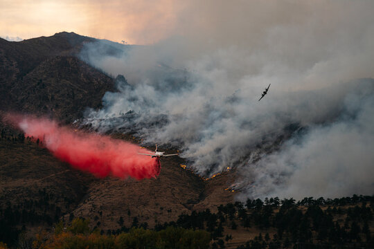 A spotter plane guides in a Slurry Bomber to help contain the Cal-Wood Fire in Boulder, Colorado 2020