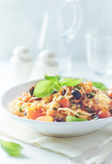 Spaghetti Pasta with Vegetables and fresh Basil on bright Background. Close up. 