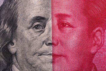 Overlapping fragmentary 100 Chinese yuan and 100 US dollar bills