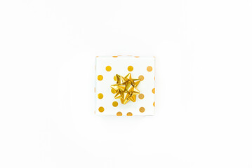 Top view of a golden dotted gift box on a white background. 