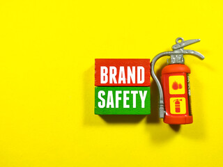 Text BRAND SAFETY with toy fire extinguishers on a yellow background.