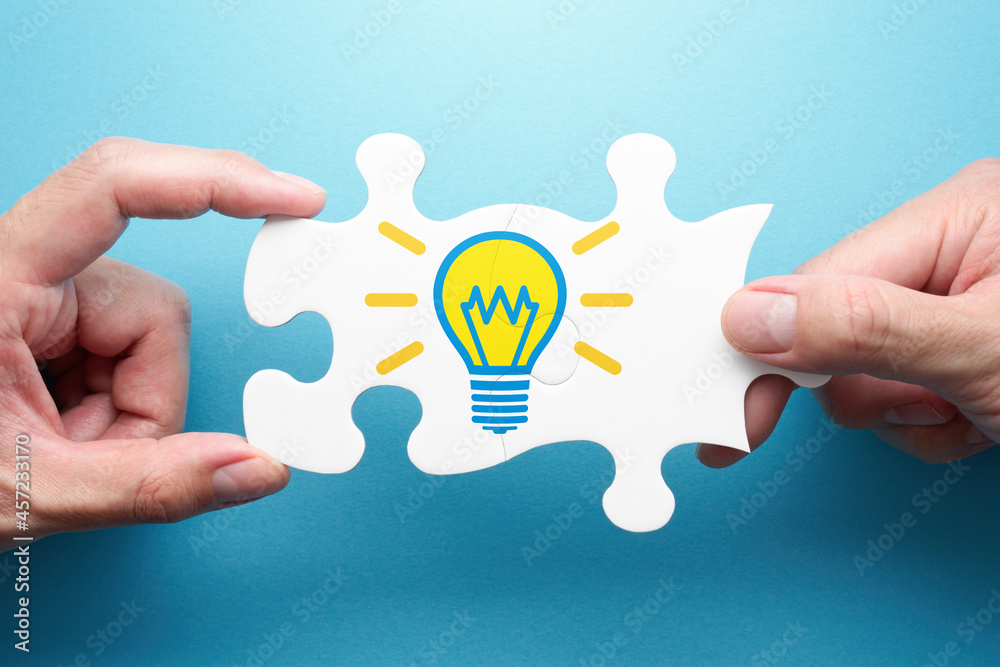 Poster inspiration and solution. two hands connecting jigsaw puzzle pieces. illustration of light bulb.