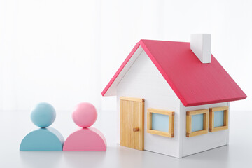 New house and life image. Miniature house and couple.