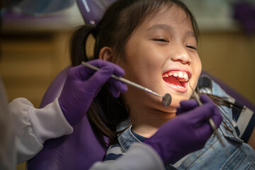 Asian dentist check up  little Asian girl teeth healthy in Dental's office. Dental care, Medical care, Lifestyle, Dental clinic or dental procedure concepts