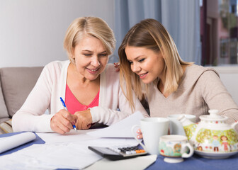 Grown daughter helps her mother deal with bills and taxes
