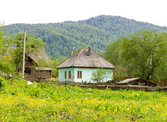 A chalet, a mountain village, an old style of architecture a variety of buildings and court buildings and fences.