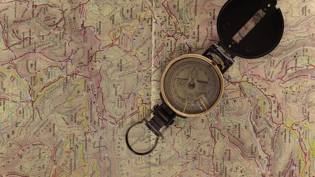 Compass spinning over a hiking map