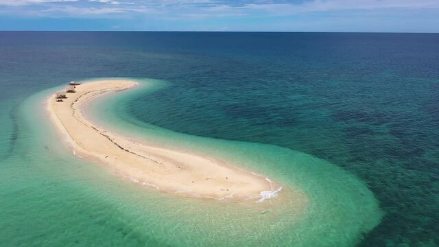 Cinematic shot , aerial view of a small Island, a sand bar in Roxas, Palawan. Summer and travel vacation concept. Tropical islands, top view.Seascape with beautiful sky and islands.
