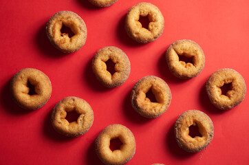 A pattern of freshly baked cinnamon donuts
