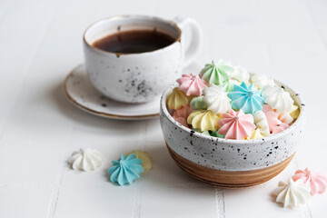 Cup with coffee and small meringues