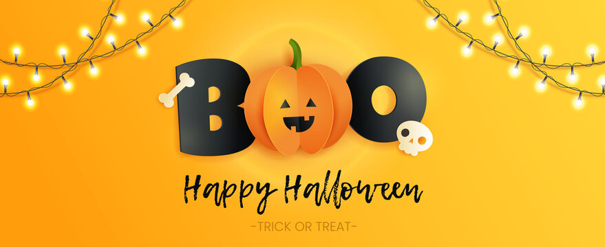 Happy Halloween horizontal card with inscription boo, skull , bone and pumpkin in paper cut style. Funny paper pumpkin with black letters on yellow background. 