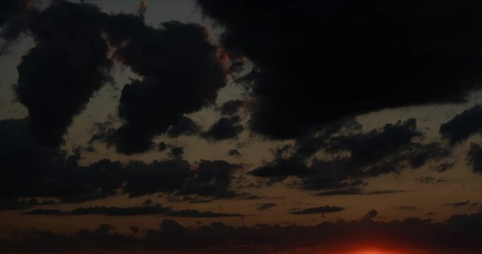 Clouds fly across the sky at sunset. Timelapse